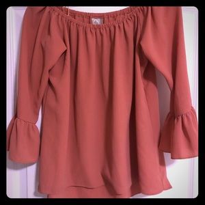 Peachy colored off the shoulders top.